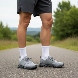 FWSports Shoes On Cloud 6 Waterproof sneakers in alloy gray worn by a man on an outdoor road