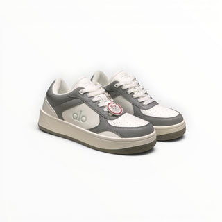FWSports Shoes Alo Yoga Recovery Mode low-top sneakers in grey and white with a cushioned sole and lace-up closure.