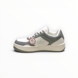 FWSports Shoes Alo Yoga Recovery Mode low-top sneakers in grey and white with cushioned soles and lace-up closure.
