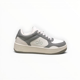 FWSports Shoes Alo Yoga Recovery Mode low-top sneakers in grey and white with a cushioned sole and lace-up design.