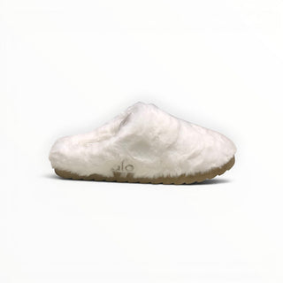 FWSports Shoes Alo Yoga white faux fur recovery slipper with a plush upper and a textured tan sole for indoor comfort.