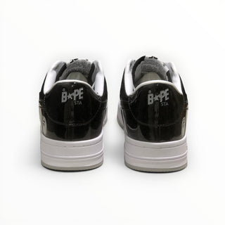 FWSports Shoes BAPE STA low-top sneakers in black and white patent leather, showing the rear heel branding.