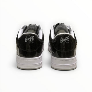 FWSports Shoes BAPE STA low-top sneakers in black and white patent leather, showing the rear heel branding.