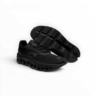FWSports Shoes Cloudmonster men's black running shoes with breathable mesh upper and oversized CloudTec cushioning.