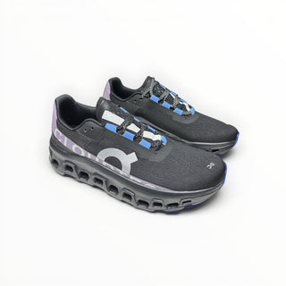 FWSports Shoes On Cloudmonster women's running shoes in black, purple, and blue with breathable mesh and CloudTec sole.