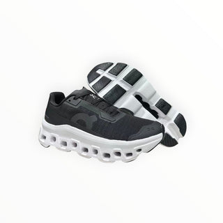 FWSports Shoes On Running Cloudmonster Void black and white running sneakers with thick CloudTec cushioning soles.