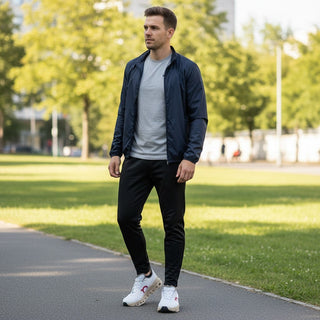 Man wearing FWSports Shoes On Running Cloudmonster Void white and gold sneakers with athletic apparel in a park