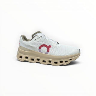 FWSports Shoes On Running Cloudmonster Void sneaker in white mesh with gold accents and a chunky cushioned sole.
