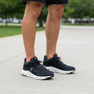 FWSports Shoes CLOUDNOVA men's black and white running sneakers with sock-like fit worn on a paved path.