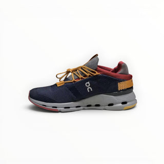 FWSports Shoes Cloudnova men's running sneakers in denim blue with a sock-like upper, yellow laces, and CloudTec cushioning.