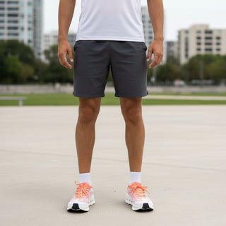 FWSports Shoes On Cloudtilt Remix sneakers in coral and peach with white CloudTec Phase soles worn by a man outdoors.