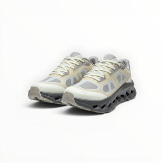 FWSports Shoes On Cloudtilt Remix men's running sneakers in cream, sand, and charcoal with layered x-ray mesh upper.