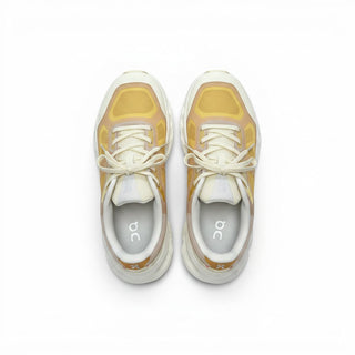FWSports Shoes On Cloudtilt Remix men's running sneakers in honey, gold, and white with layered see-through upper.