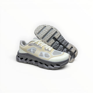 FWSports Shoes On Cloudtilt Remix women's running sneakers in cream, sand, and charcoal with layered x-ray mesh upper.