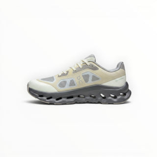 FWSports Shoes On Cloudtilt Remix women's running sneaker in cream, sand, and charcoal with a layered x-ray upper.