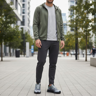 FWSports Shoes On Cloudtilt Remix sneakers in grey, black, and lime worn by a man in an urban setting.