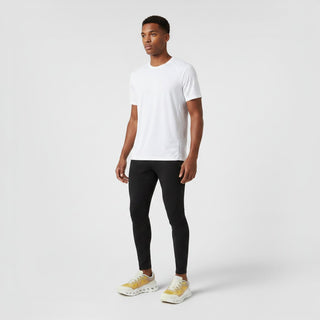 FWSports Shoes model wearing On Cloudtilt Remix sneakers in honey, gold, and white with a white tee and black leggings.
