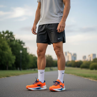 FWSports Shoes Glycerin Max 2 orange running shoes with plush cushioning worn by a man on a paved park path