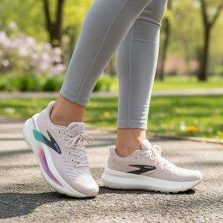 FWSports Shoes Glycerin Max 2 women's running shoes in pink with thick white cushioned soles, worn on a park path.