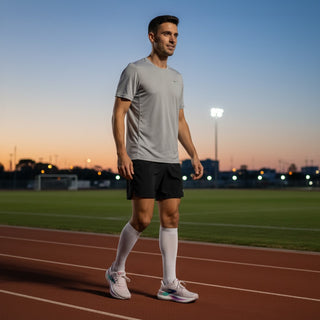 A male runner wearing FWSports Shoes Glycerin Max 2 pink running shoes on a track at sunset.