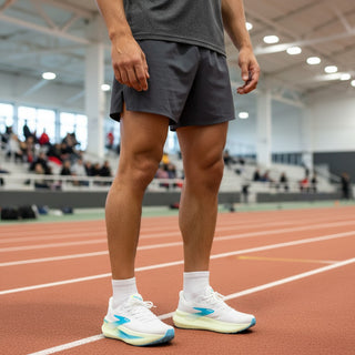 FWSports Shoes Glycerin Max 2 running shoes in white with light blue and gold accents worn by a runner on a track.