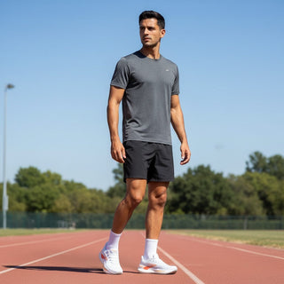 FWSports Shoes Glycerin Max 2 running shoes in white and orange worn by a male athlete on a track