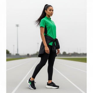 FWSports Shoes Glycerin Max 2 running shoes in black and green worn by a female athlete on a track.