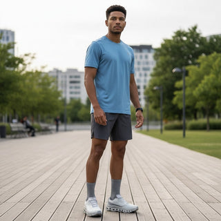 FWSports Shoes model wearing grey On Running Cloudmonster Void sneakers with mesh upper and responsive cushioning.