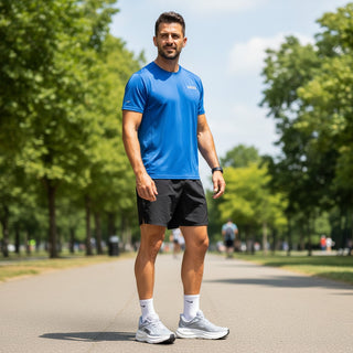 FWSports Shoes model wearing grey Hoka Bondi 9 running shoes with plush cushioning on a park path