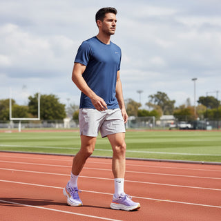 FWSports Shoes model walking on a track wearing purple Hoka Bondi 9 running shoes with plush cushioning