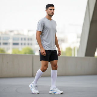 FWSports Shoes model wearing Hoka Bondi 9 white and purple running shoes with white socks in an urban setting.