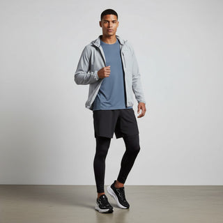 FWSports Shoes model wearing Hoka Clifton 10 black and white running shoes with athletic gear in a studio setting