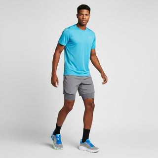 FWSports Shoes model wearing Hoka Clifton 10 grey and blue running shoes with athletic shorts and a blue t-shirt