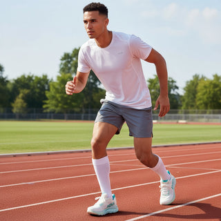 FWSports Shoes Hoka Clifton 10 running shoes in light blue and white on a male athlete at a track