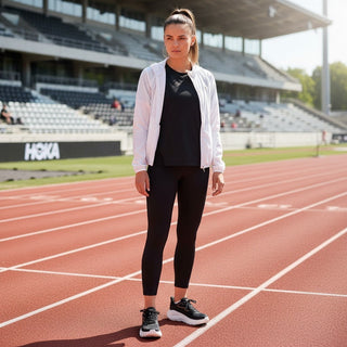 FWSports Shoes model wearing black and brown Hoka Clifton 10 running shoes on a stadium track