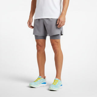 FWSports Shoes Hoka Clifton 10 running shoes in blue, green, and yellow on a male runner wearing grey athletic shorts.