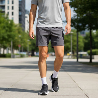 FWSports Shoes Mens On-Run Cloudtilt black and white sneakers worn by a man walking on a city path