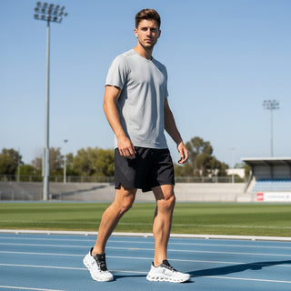 FWSports Shoes Mens On-Run Cloudtilt sneakers in white and black on a track with a male athlete