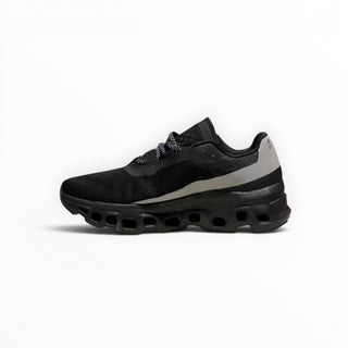 FWSports Shoes On Cloudmonster men's running shoe in black and silver with breathable mesh and thick CloudTec sole.