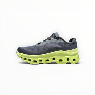FWSports Shoes On Cloudmonster men's running shoe in black mesh with a vibrant acacia yellow cushioned CloudTec sole.