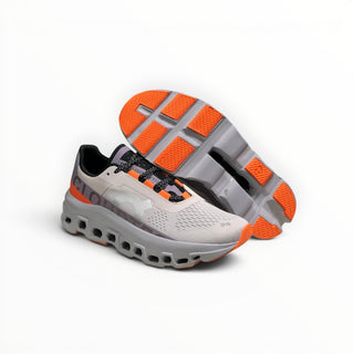 FWSports Shoes On Cloudmonster men's running shoes in gray and orange with breathable mesh and CloudTec cushioning.