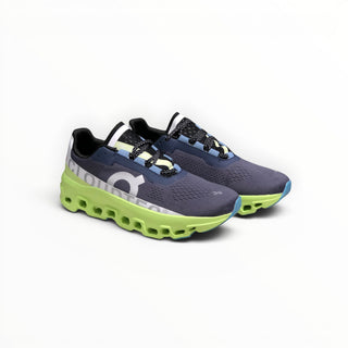 FWSports Shoes On Cloudmonster women's running shoes in iron black with lime green oversized CloudTec cushioning.