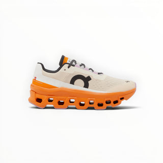 FWSports Shoes On Cloudmonster women's running shoe in yellowish white with a bold orange CloudTec cushioned midsole.