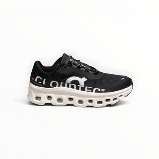 FWSports Shoes On Cloudmonster men's running shoe in black and white with breathable mesh and thick CloudTec cushioning.