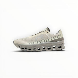 FWSports Shoes On Cloudmonster running shoes in ice white and alloy grey with breathable mesh and CloudTec cushioning.
