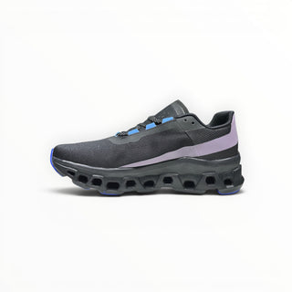 FWSports Shoes On Cloudmonster women's running shoe in black with purple and blue accents and thick CloudTec sole.
