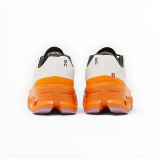 FWSports Shoes On Cloudmonster women's running shoes in yellowish white and orange, rear view showing CloudTec sole.