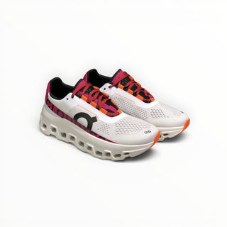 FWSports Shoes On Cloudmonster women's running shoes in undyed white mesh with aurora pink and orange accents.