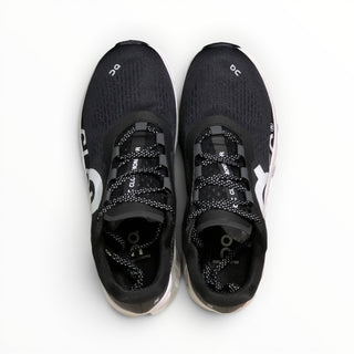 FWSports Shoes On Cloudmonster men's running shoes in black and white with breathable mesh and cushioned soles.