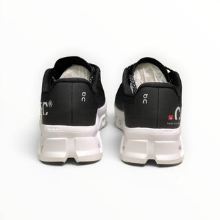 FWSports Shoes On Cloudmonster men's running shoes in black and white, showing the rear view of the cushioned midsole.